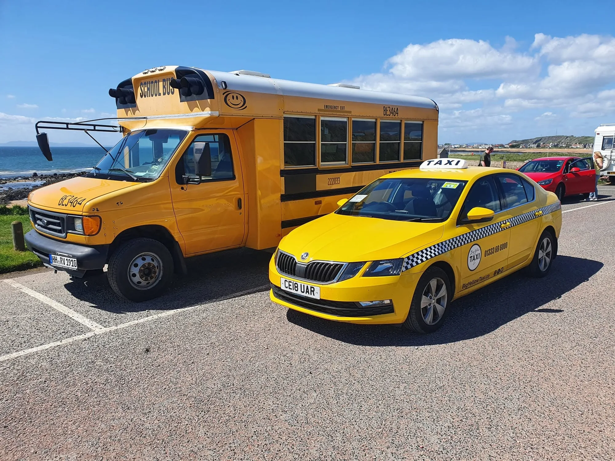 The Big Yellow Taxi parked next to a traditional US school bus